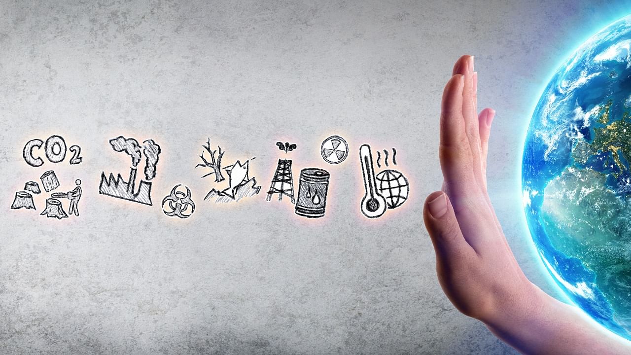 Representative picture of a hand shielding a model of the earth from pollutants. Credit: iStock Images