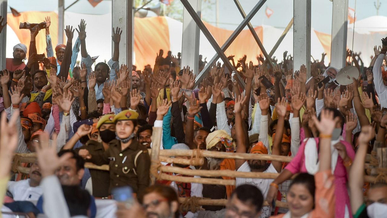 BJP supporters attend a public meeting of Prime Minister Narendra Modi (unseen) for the seventh and last phase of UP Assembly elections at Khajuri village, in Varanasi. Credit: PTI Photo