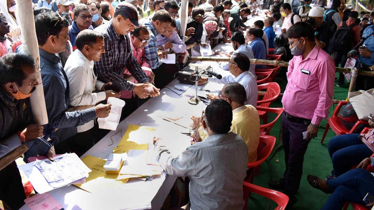 Polling parties collect election material at a distribution centre to leave for polling stations, a day before the 7th and final phase of Assembly polls, in Varanasi, Sunday, March 6, 2022. Credit: PTI Photo