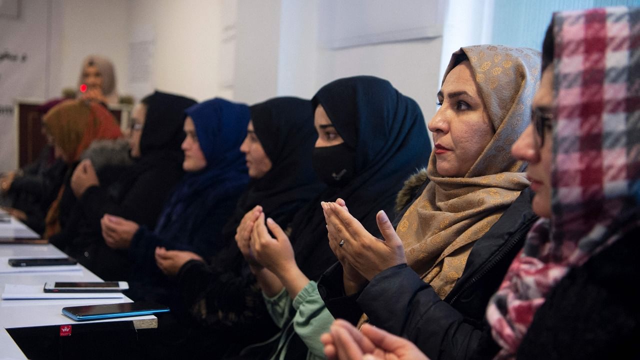 Members of the Afghan women's peace and freedom organisation pray during an event on the occasion of International Women's Day in Kabul. Credit: AFP Photo