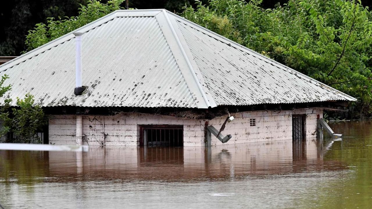 A house is seen inundated by the floodwater in southwestern suburb of Camden on March 8, 2022 in Sydney. Credit: AFP Photo