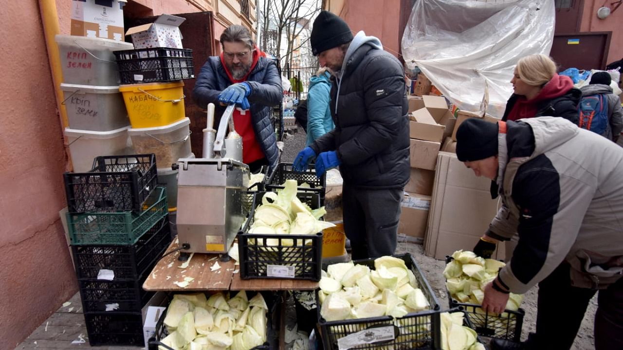 People from the Lviv Volunteer Kitchen prepare food and dry rations for the Ukrainian military on the front lines, amid Russia's invasion of Ukraine. Credit: Reuters photo