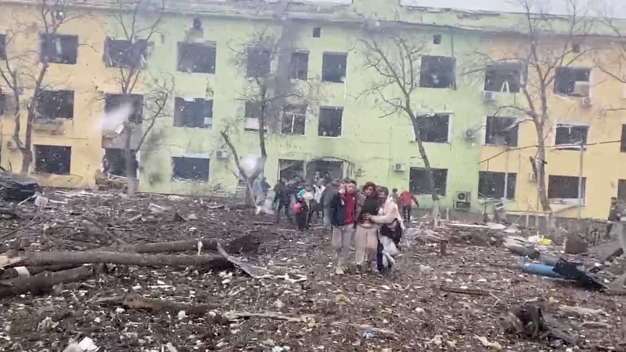 A person is carried out after the destruction of Mariupol children's hospital as Russia's invasion of Ukraine continues, in Mariupol, Ukraine, March 9, 2022 in this still image from a handout video obtained by Reuters. Credit: Ukraine Military/Handout via Reuters