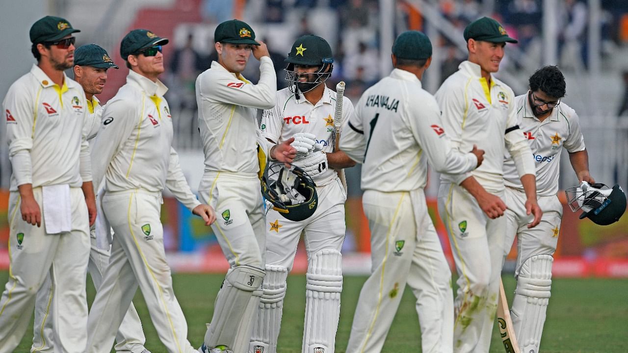Players of Pakistan's and Australia's leave the ground after a draw in the first Test cricket match between Pakistan and Australia at the Rawalpindi Cricket Stadium. Credit: AFP Photo