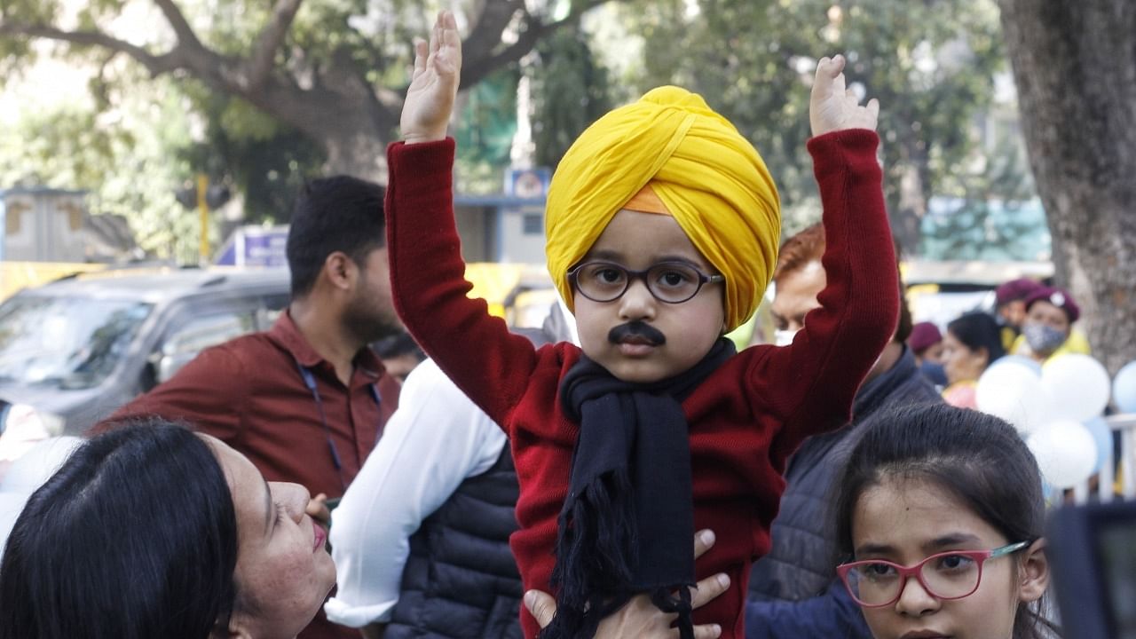 3-year-old Avyaan Tomar dressed as AAP national convener Arvind Kejriwal poses for photographs during the counting of votes for the Punjab assembly elections at the party office in New Delhi on Thursday, March 10, 2022. Credit: IANS Photo