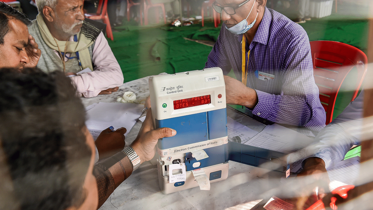 Polling officials check the Electronic Voting Machines (EVM) during the counting day of UP Assembly elections, in Kanpur. Credit: PTI Photo