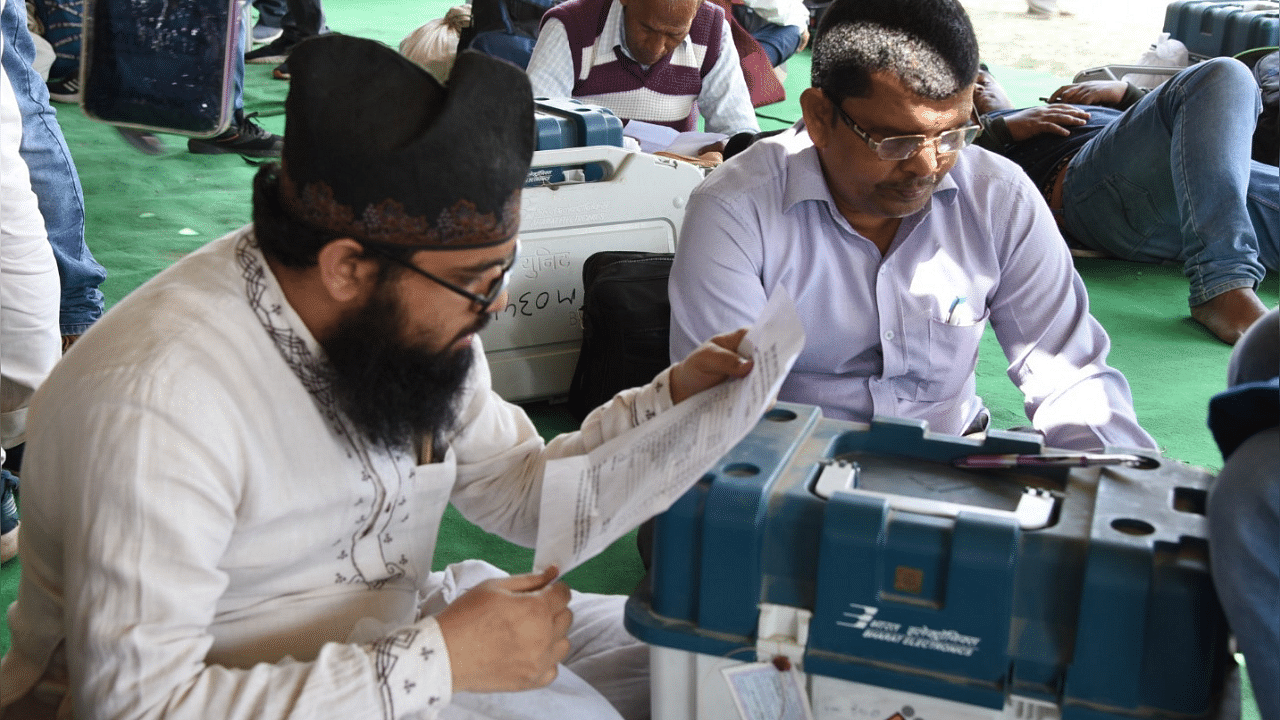 Polling officials checking the Electronic Voting Machine (EVM) in Varanasi, UP. Credit: IANS Photo