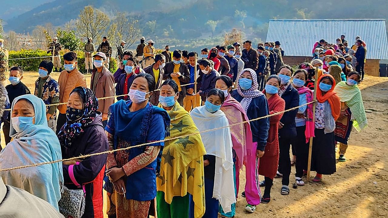 People wait in queues to cast their votes at a polling station, during the repolls of few Manipur Assembly constituencies. Credit: PTI File Photo