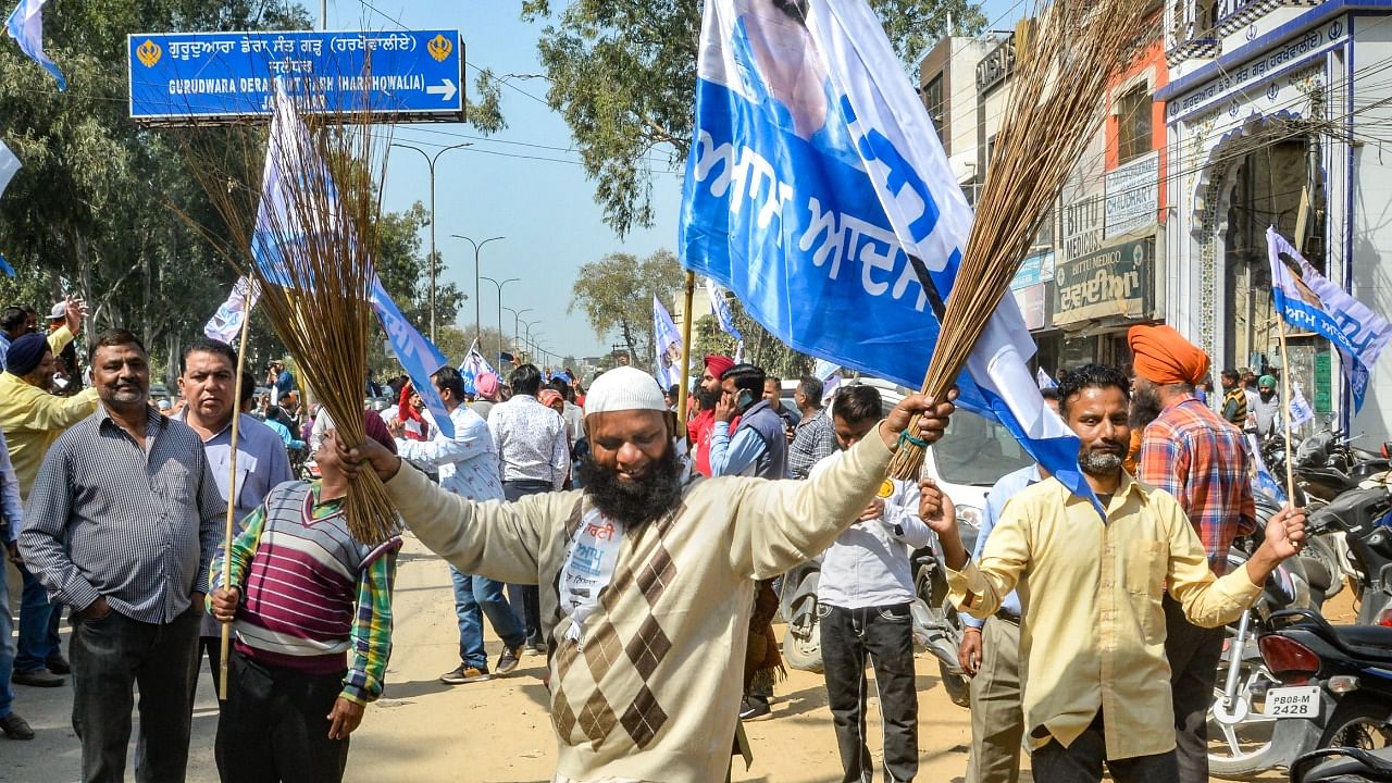 AAP supporters celebrate their party's lead during the counting day of Punjab Assembly elections, in Jalandhar district. Credit: PTI Photo