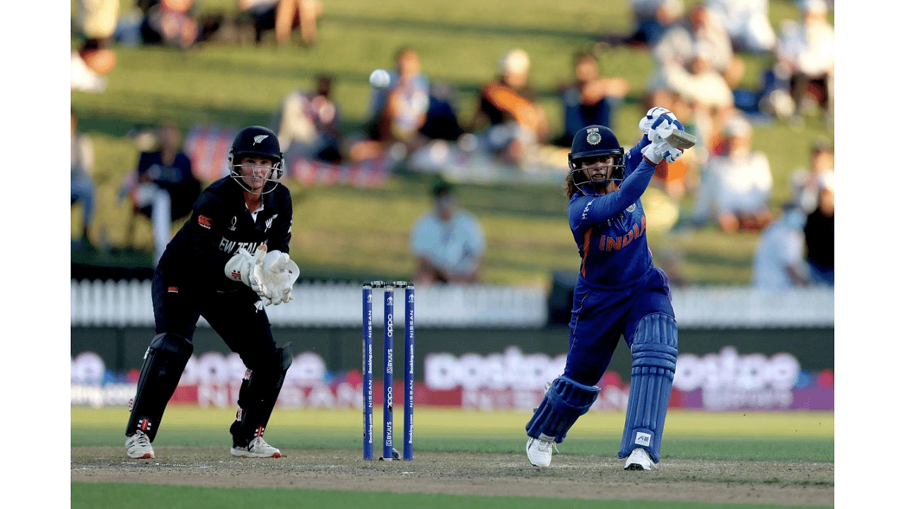 Mithali Raj  plays a shot as New Zealand's wicketkeeper Katey Martin looks on during the 2022 Women's Cricket World Cup match between New Zealand and India at Seddon Park in Hamilton on March 10.  Credit: AFP Photo