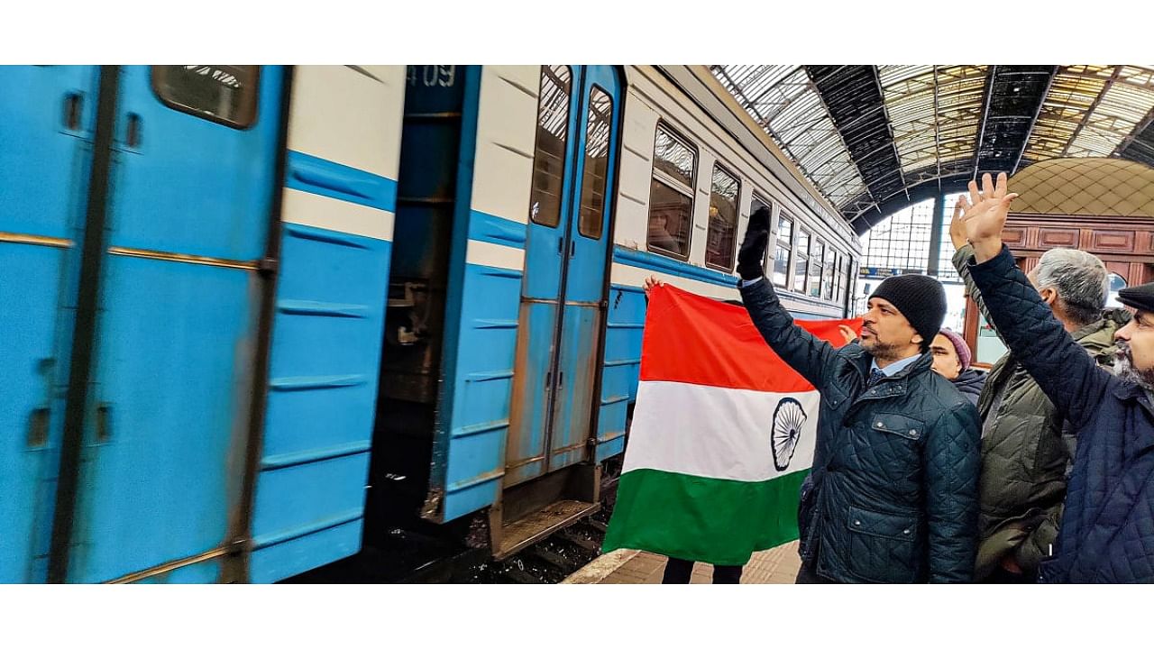 Indian Ambassador to Ukraine Partha Satpathy flags off a special train with 600 Indian students from Sumy University at Lviv Railway Station, in Ukraine. They will travel to Poland and are expected to board evacuation flights to India. Credit: PTI Photo