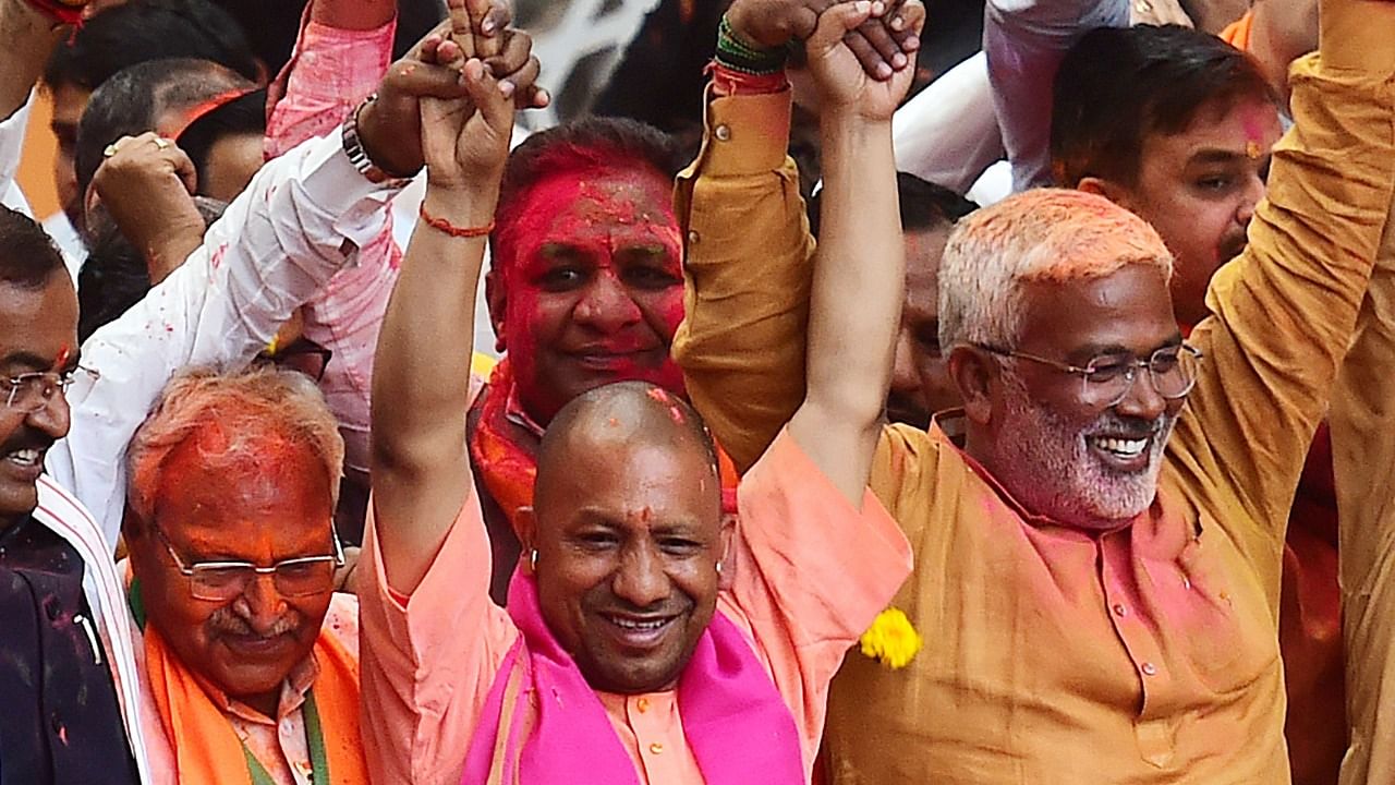 Uttar Pradesh Chief Minister Yogi Adityanath gestures to his supporters after BJP's win in the state assembly elections at the party office in Lucknow. Credit: AFP Photo