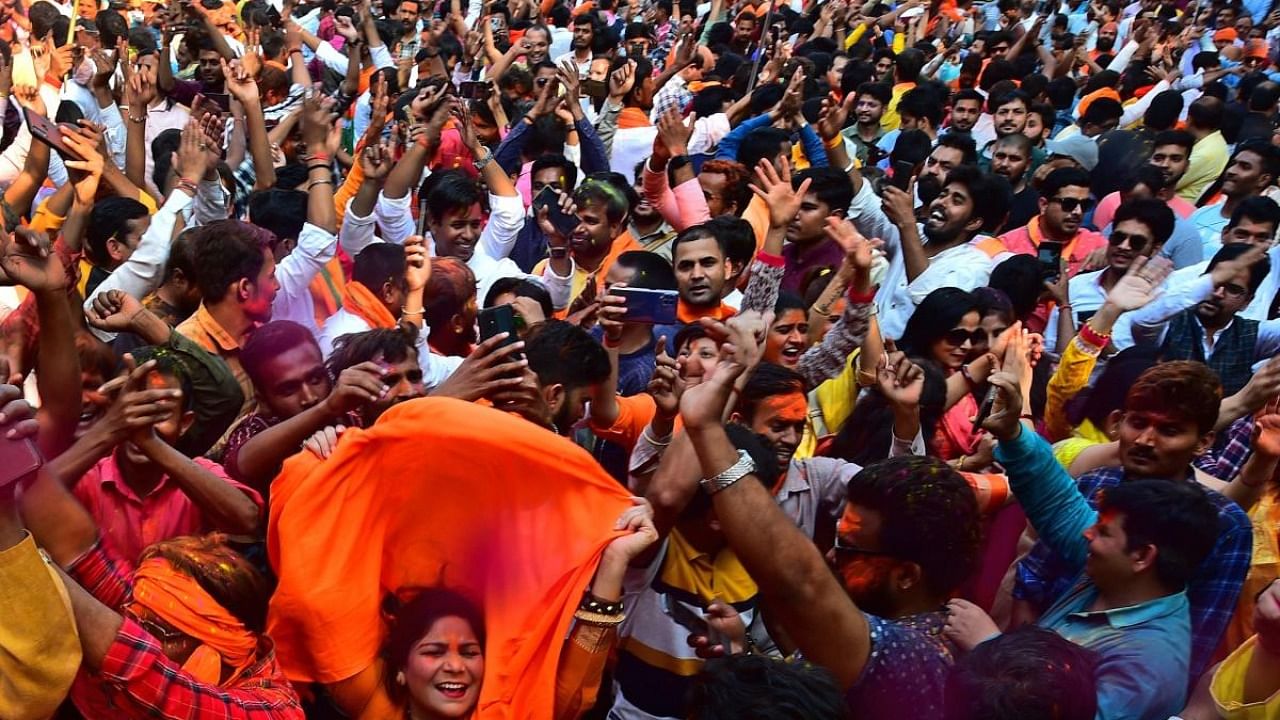 Supporters of the Bharatiya Janata Party (BJP) celebrate their party's win in Uttar Pradesh state assembly elections outside the party office in Lucknow. Credit: AFP Photo