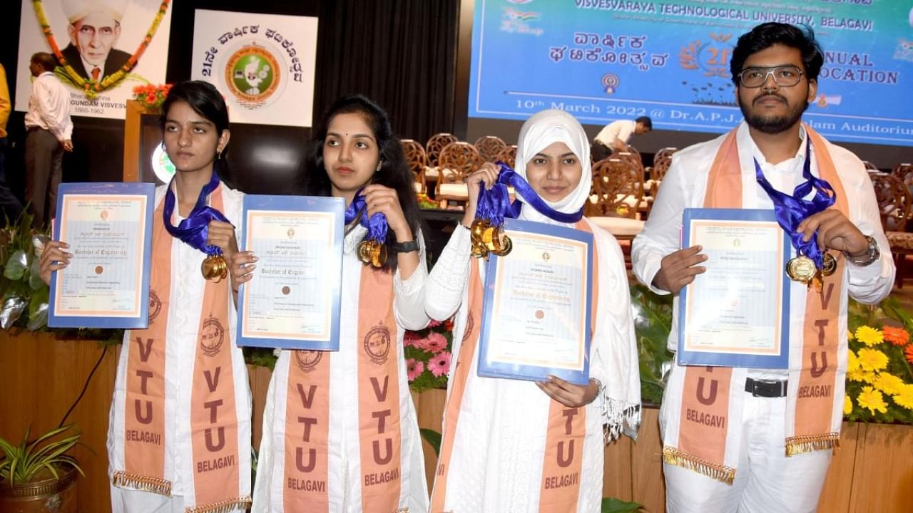 Students flaunt their medals and certificates at the 21st convocation of Visvesvaraya Technological University (VTU) in Belagavi on Thursday. Credit: DH photo