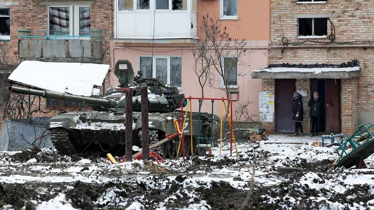 A tank with the letters "Z" painted on it is seen in front of a residential building which was damaged during Ukraine-Russia conflict in the separatist-controlled town of Volnovakha. Credit: Reuters Photo