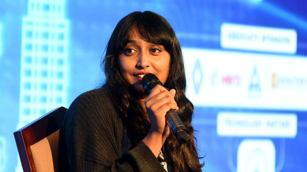 Climate justice activist Disha Ravi talks during a session at the Deccan Herald Bengaluru 2040 summit on Friday, March 11, 2022. Credit: DH photo/Pushkar V