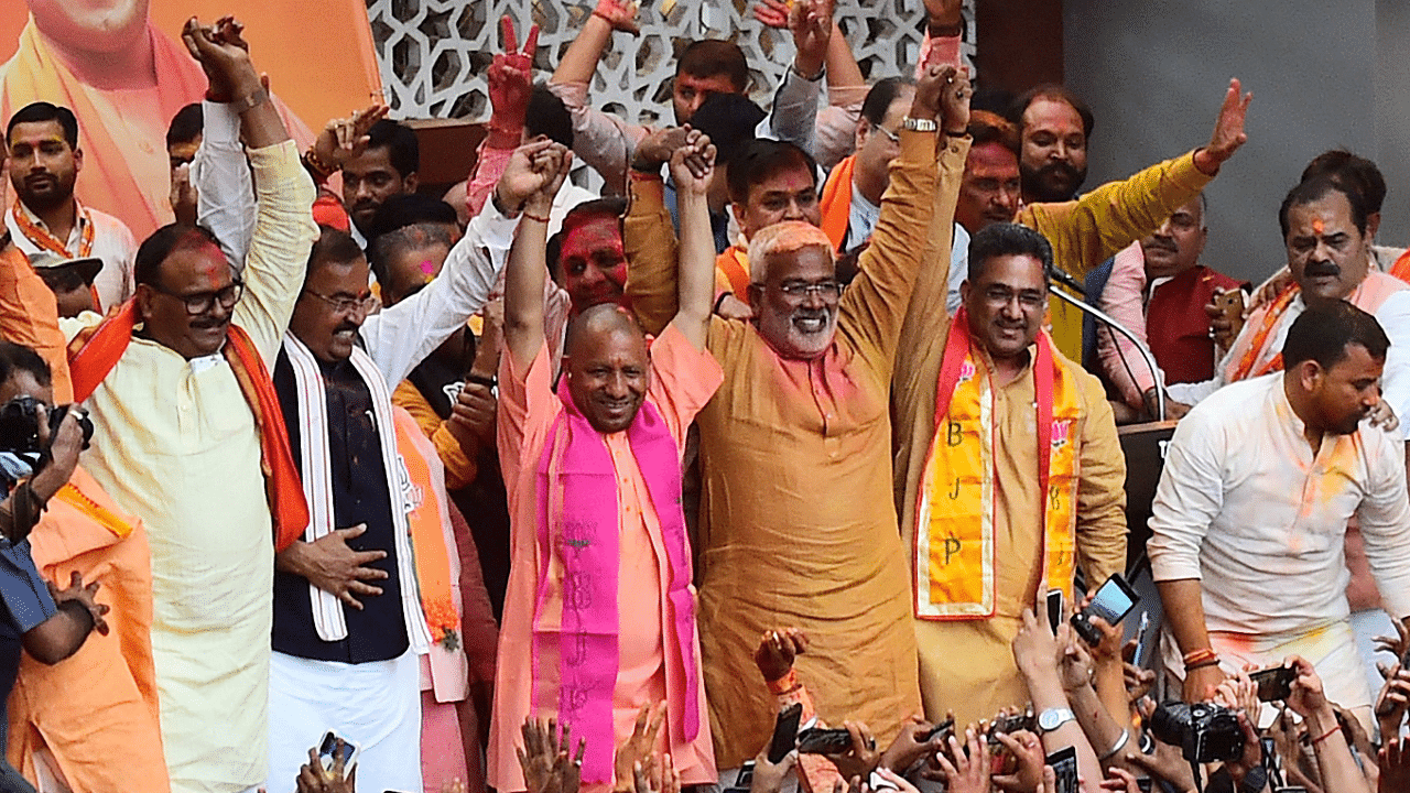 Yogi Adityanath gestures to his supporters after BJP's win in the state assembly elections at the party office in Lucknow. Credit: AFP Photo