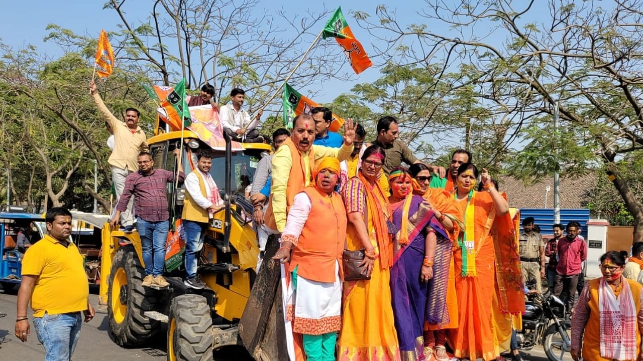 BJP supporters standing on a bulldozer celebrate after the party's winning in four states assembly election, in Patna. Credit: IANS Photo