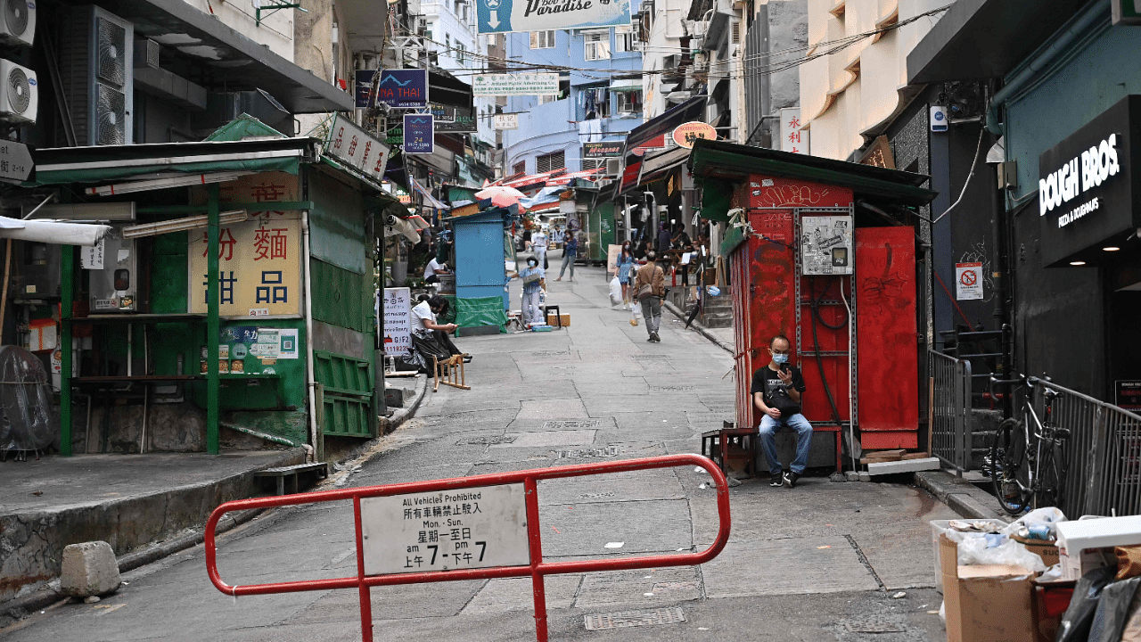 A man looks at his phone on an empty street in Hong Kong. Credit: AFP Photo
