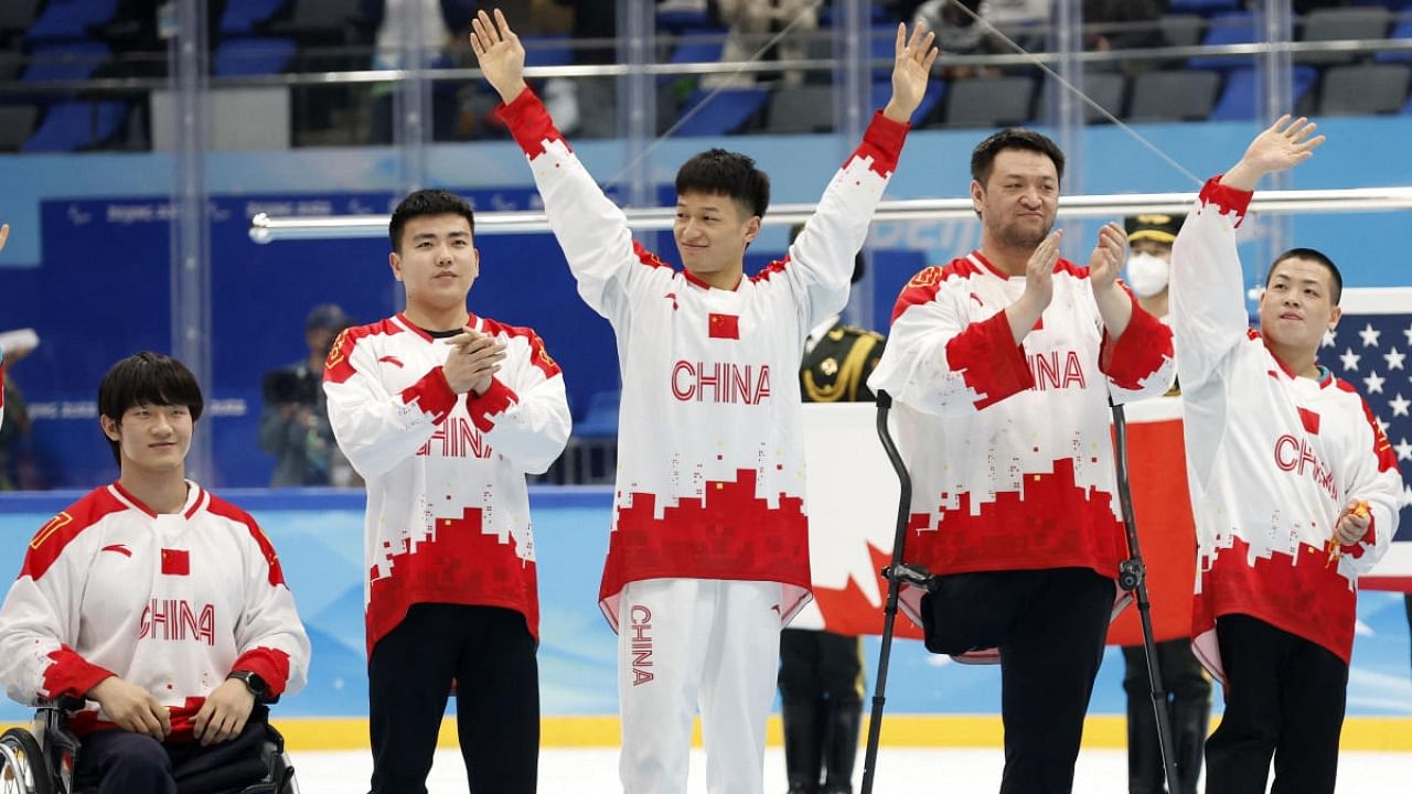 Para Ice Hockey - Bronze medallists team China players acknowledge the crowd during the medal ceremony.  Credit: Reuters Photo