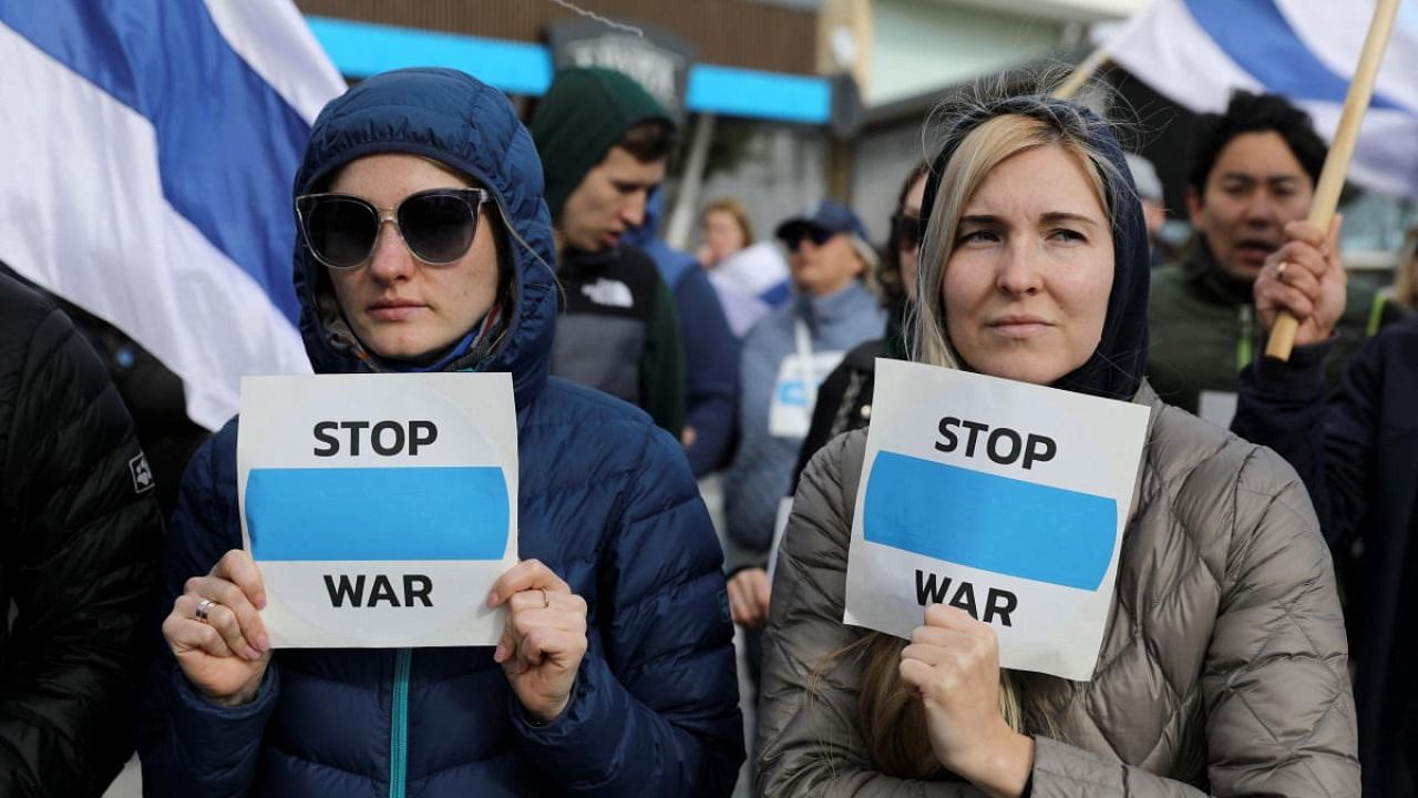 Protesters hold anti-war signs, while taking part in a demonstration against Russia's invasion of Ukraine, in Limassol. Credit: Reuters photo