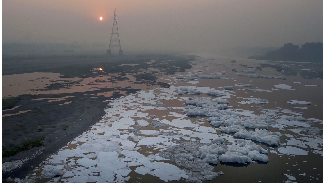 Toxic foam floats on the surface of Yamuna River at Kalindi Kunj, in New Delhi. Credit: PTI File Photo