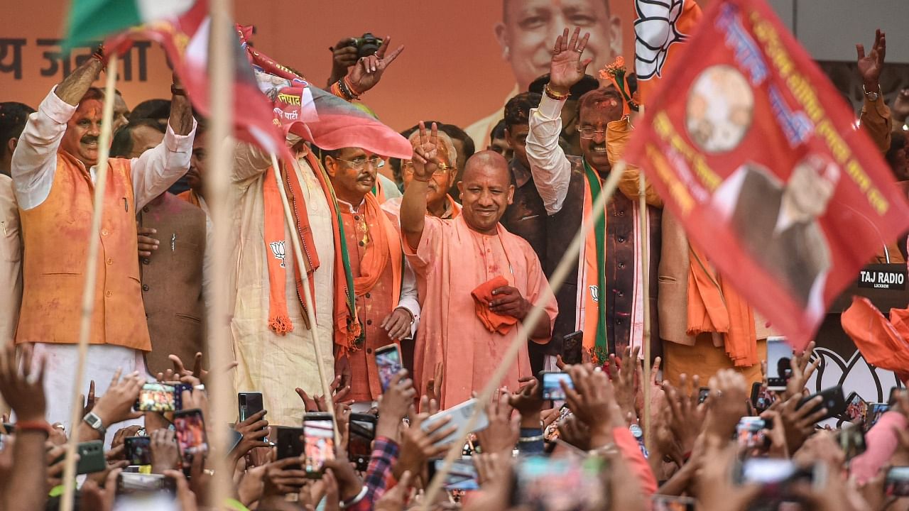  UP Chief Minister Yogi Adityanath flashes the victory sign after his victory in UP Assembly polls during a celebration at the party office, in Lucknow. Credit: PTI Photo