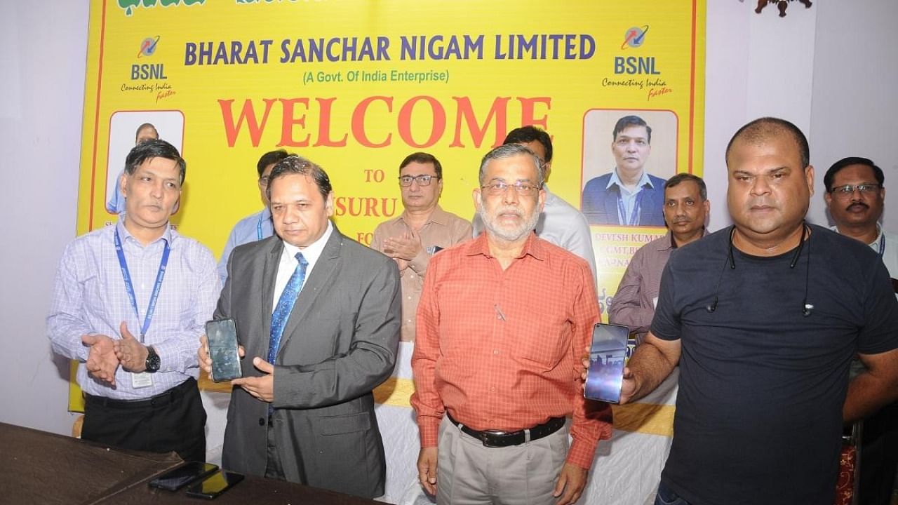 Director, Consumer Fixed Access, BSNL, Vivek Banzal launches WiFi services under Public Data Office at Rammanahalli on the outskirts of Mysuru recently. BSNL Chief General Manager Devesh Kumar and Senior General Manager Rajkumar are seen. Credit: DH Photo