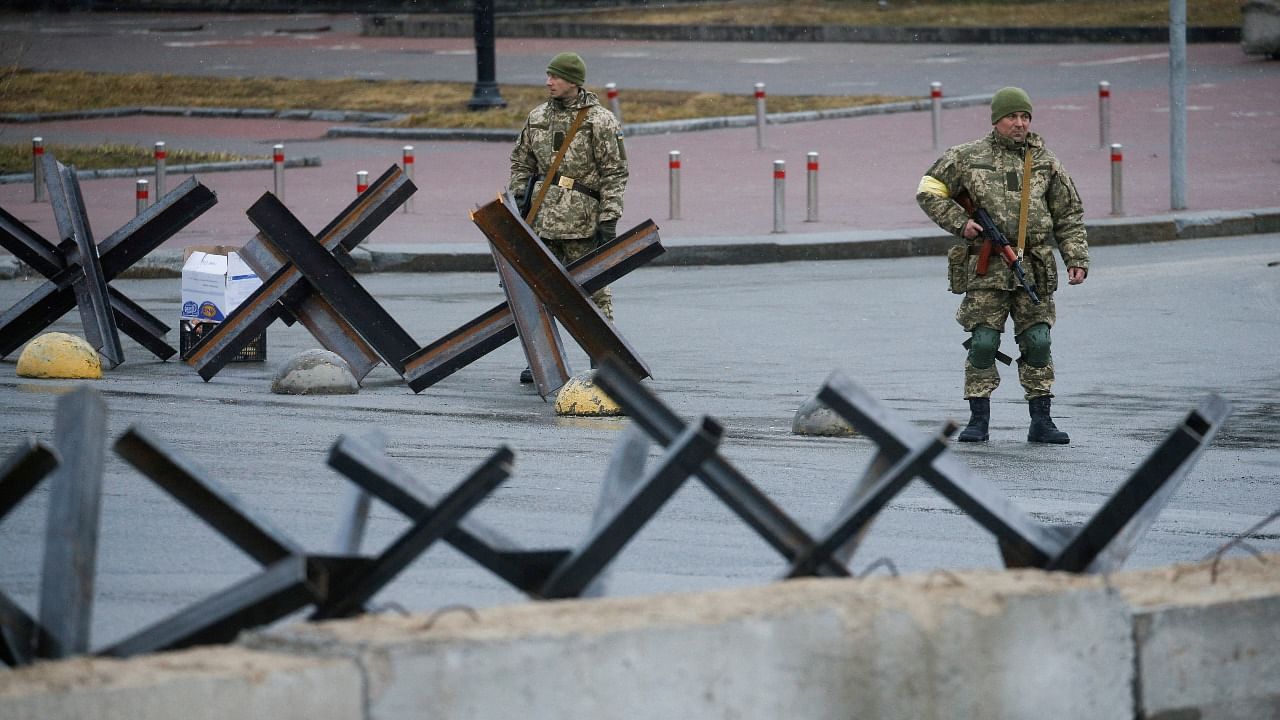 Members of the Territorial Defence Force stand guard at a check point in central Kyiv. Credit: Reuters File Photo