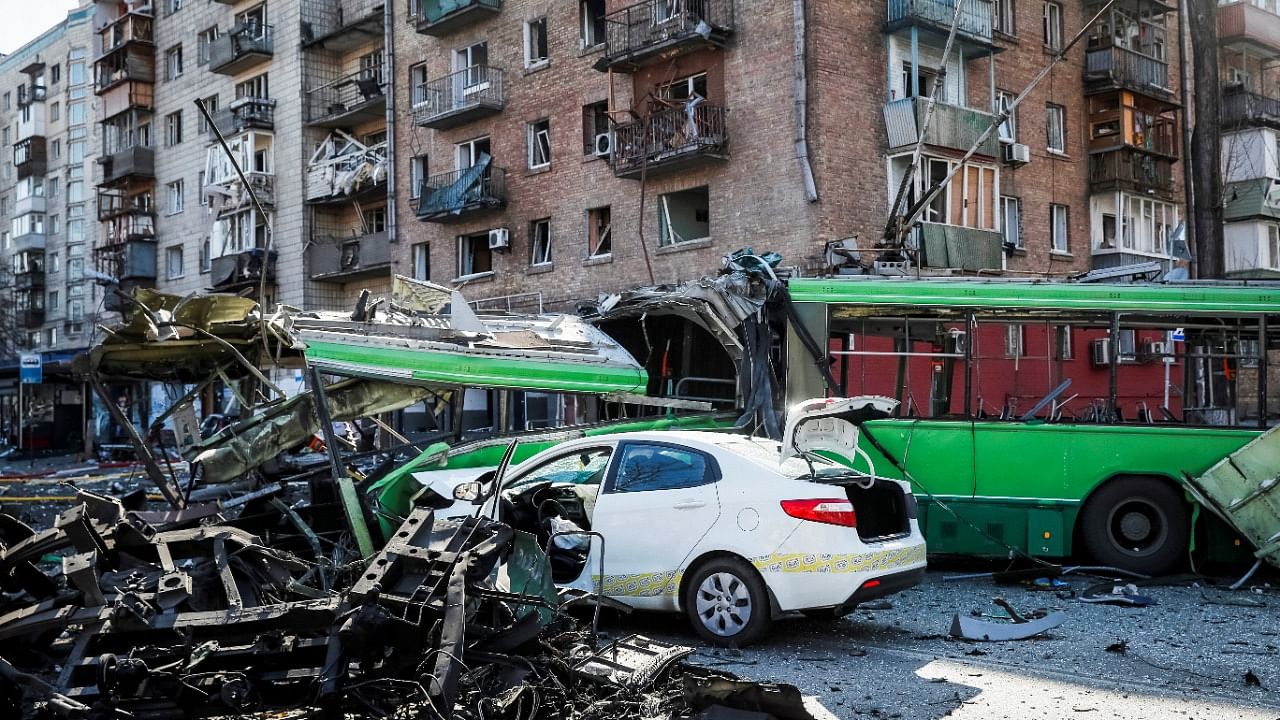 A view shows a building and vehicles destroyed by shelling as Russia's attack on Ukraine continues, in Kyiv, Ukraine March 14, 2022. Credit: Reuters Photo