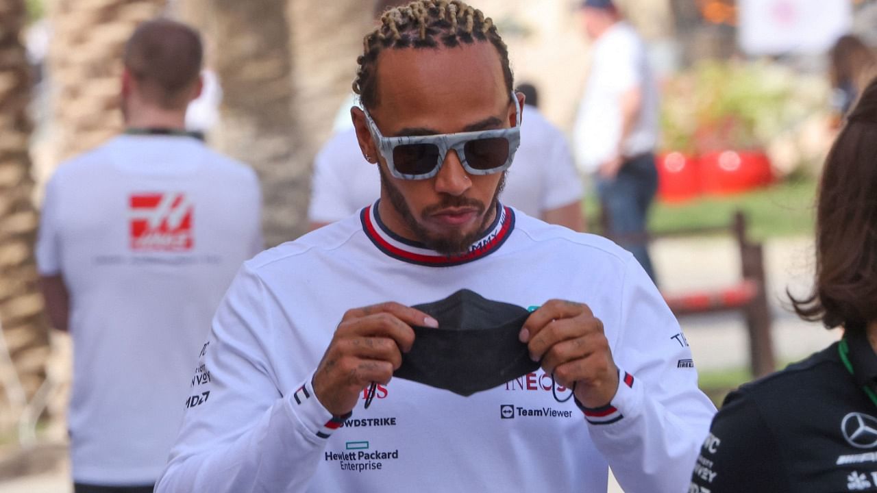 Mercedes' British driver Lewis Hamilton is pictured in the paddock during the third day of Formula One (F1) pre-season testing at the Bahrain International Circuit in the city of Sakhir. Credit: AFP Photo