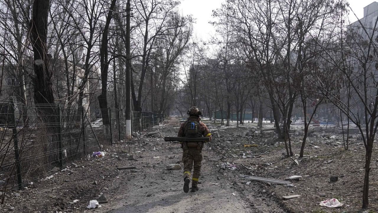 A Ukrainian serviceman walks near the position he was guarding in Mariupol, Ukraine. Credit: AP Photo
