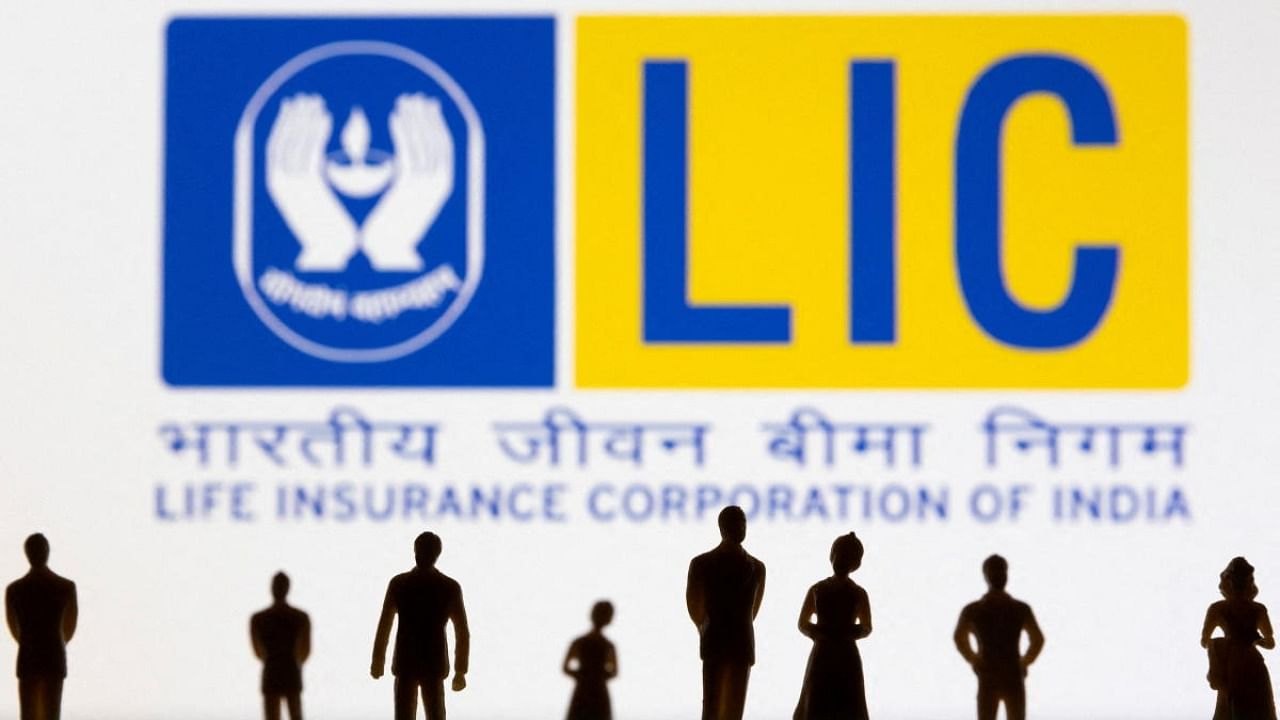 Life Insurance Corporation of India (LIC) logo is seen displayed behind figurines in this illustration taken February 20, 2022. Credit: Reuters Photo