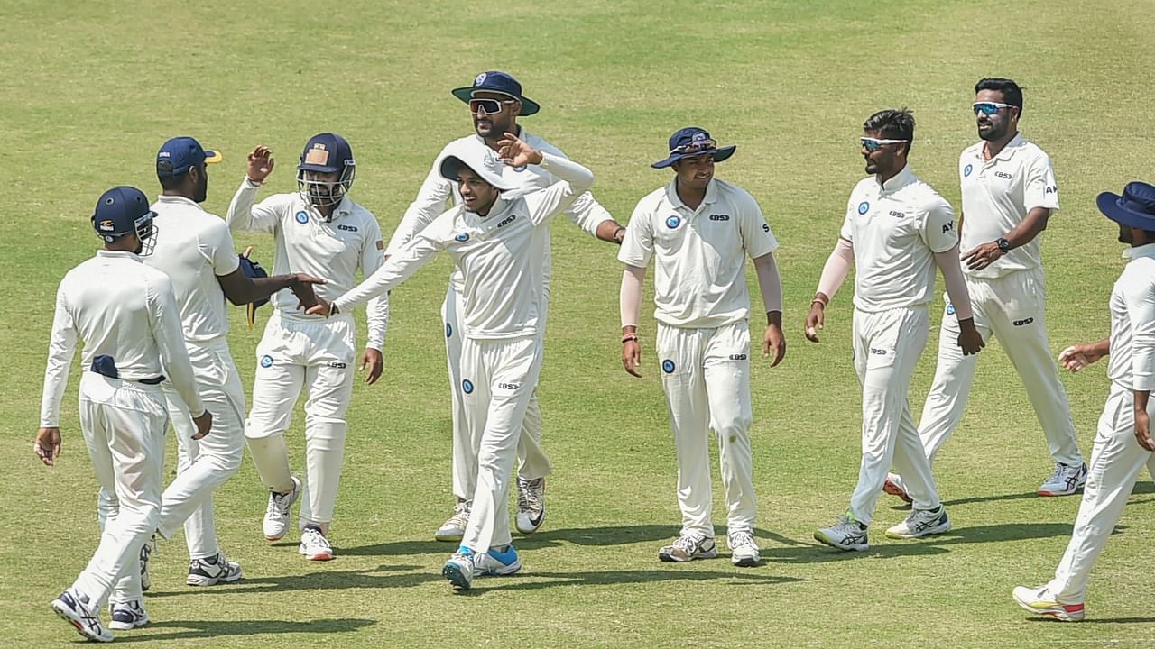 Jharkhand's cricketers celebrate after the runout of Nagaland's batter Yugandhar Singh during the preliminary quarterfinal cricket match of Ranji Trophy between Jharkhand and Nagaland at Eden Garden, in Kolkata, Monday, March 14, 2022. Credit: PTI Photo