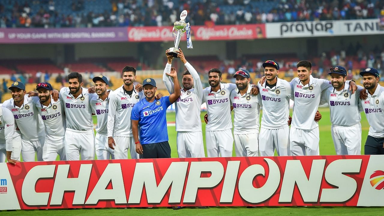 India players Priyank Panchal and Saurabh Kumar lift the trophy after clinching the Sri Lanka Test series 2-0 at the Chinnaswamy Stadium, Bengaluru. Credit: PTI Photo