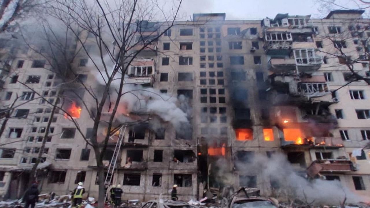 Rescuers work next to a residential building damaged by shelling, as Russia's attack on Ukraine continues, in Kyiv, Ukraine, in this handout picture released March 14, 2022. Credit: Reuters Photo