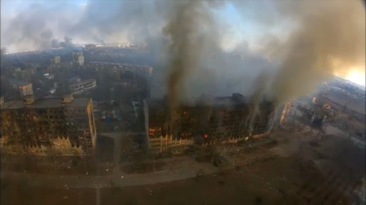 An aerial view shows smoke rising from damaged residential buildings following an explosion, amid Russia's invasion of Ukraine, in Mariupol. Credit: Reuters Photo