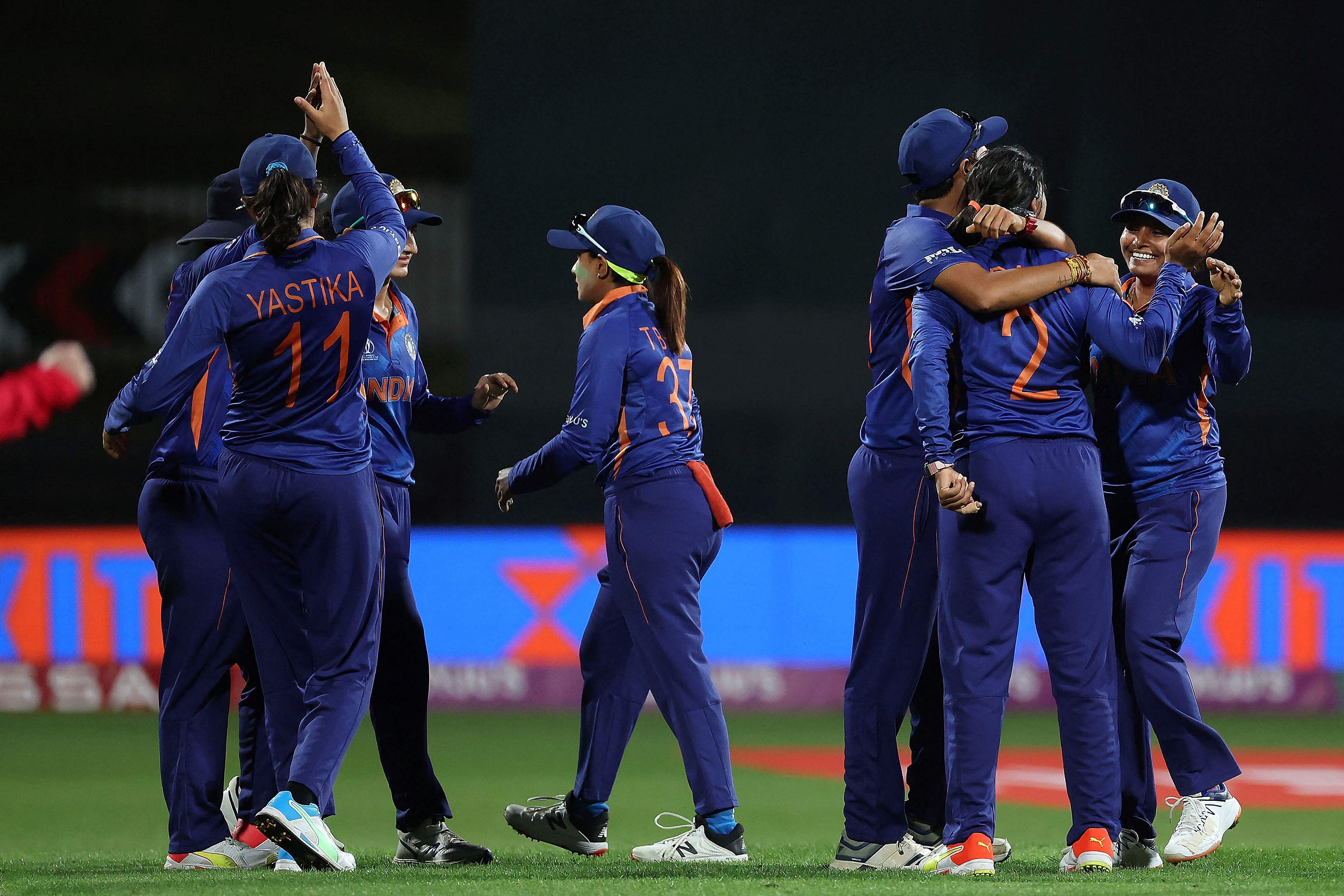 Indian players celebrate after winning the 2022 Women's Cricket World Cup match between West Indies and India at Seddon Park in Hamilton. Credit: AFP Photo
