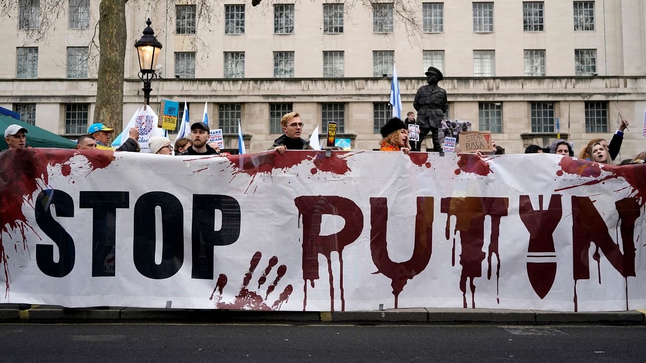 People take part in a rally in support of Ukraine, in near Downing Street on Whitehall in central London on March 13, 2022, following the invasion of the country by Russia. Credit: AFP Photo