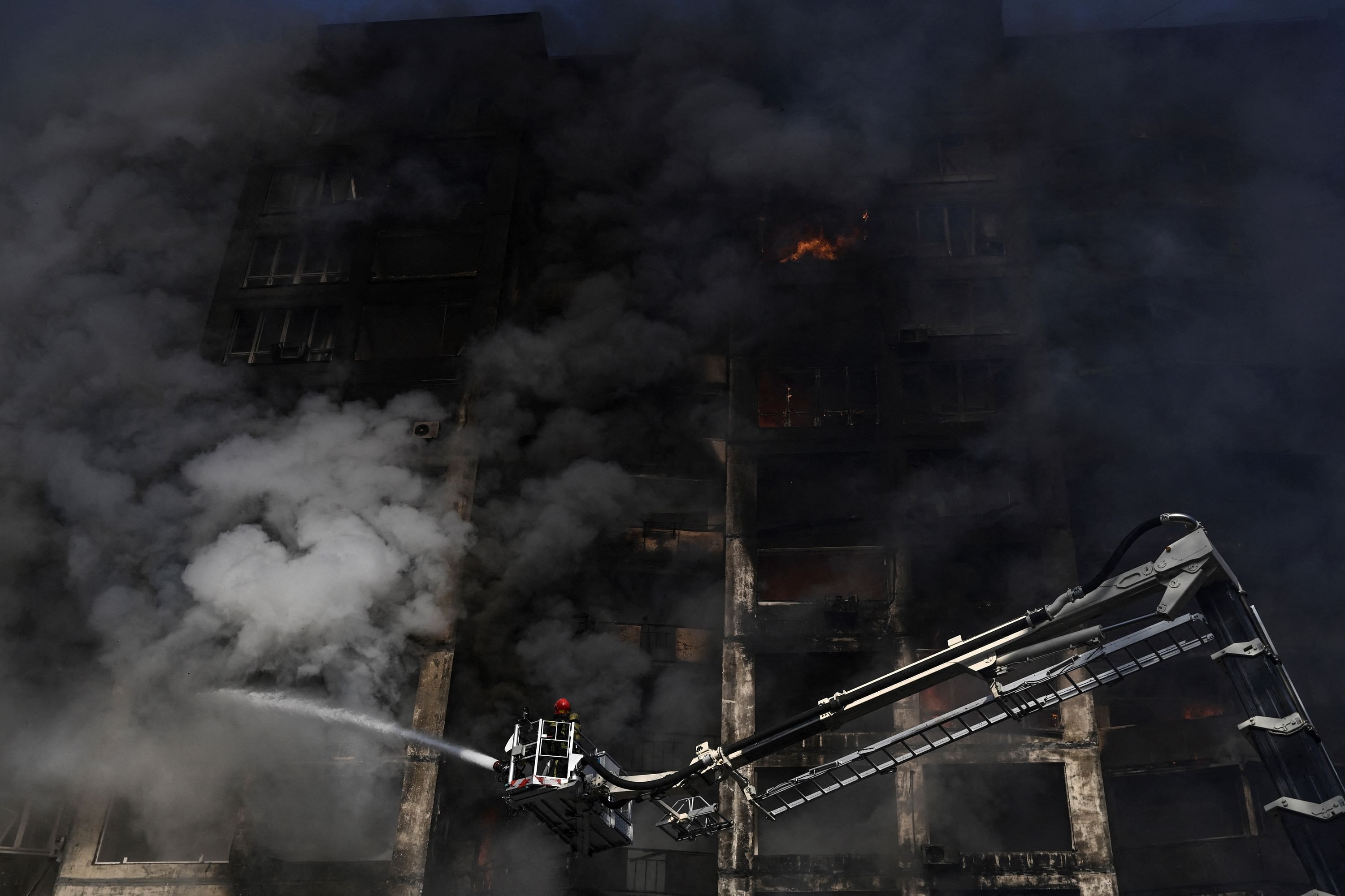 Firemen are at work to extinguish a fire that broke out in an apartment building hit by shelling in Kyiv. Credit: AFP File Photo