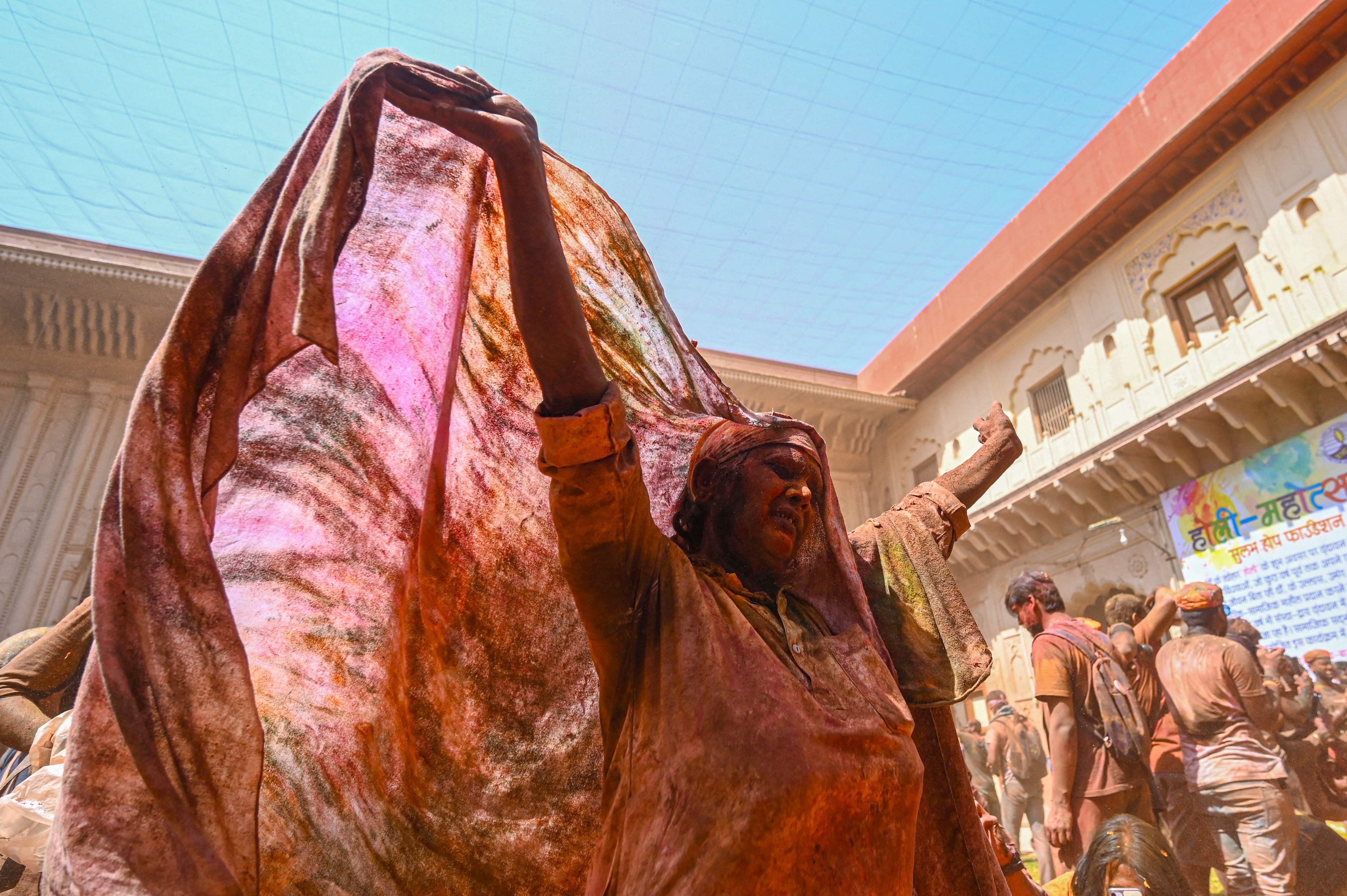 A widow smeared with Gulal (colour powder) dances as she participates in Holi celebrations, the Hindu spring festival of colours, at a temple in Vrindavan. Credit: AFP Photo