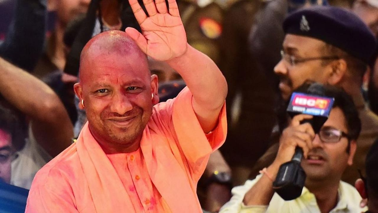 Chief Minister of Uttar Pradesh, Yogi Adityanath gestures to his supporters after Bharatiya Janata Party's (BJP) win in the state assembly elections at the party office in Lucknow on March 10, 2022. Credit: AFP Photo