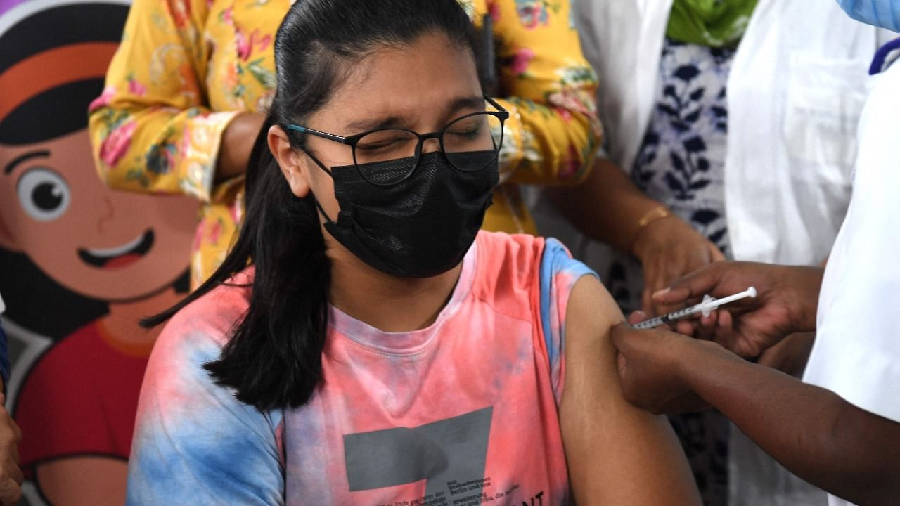 A health worker inoculates a youth with a dose of a Covid-19 Corbevax vaccine during a vaccination drive for people in the 12-14 age group at a vaccination centre in Mumbai. Credit: AFP Photo