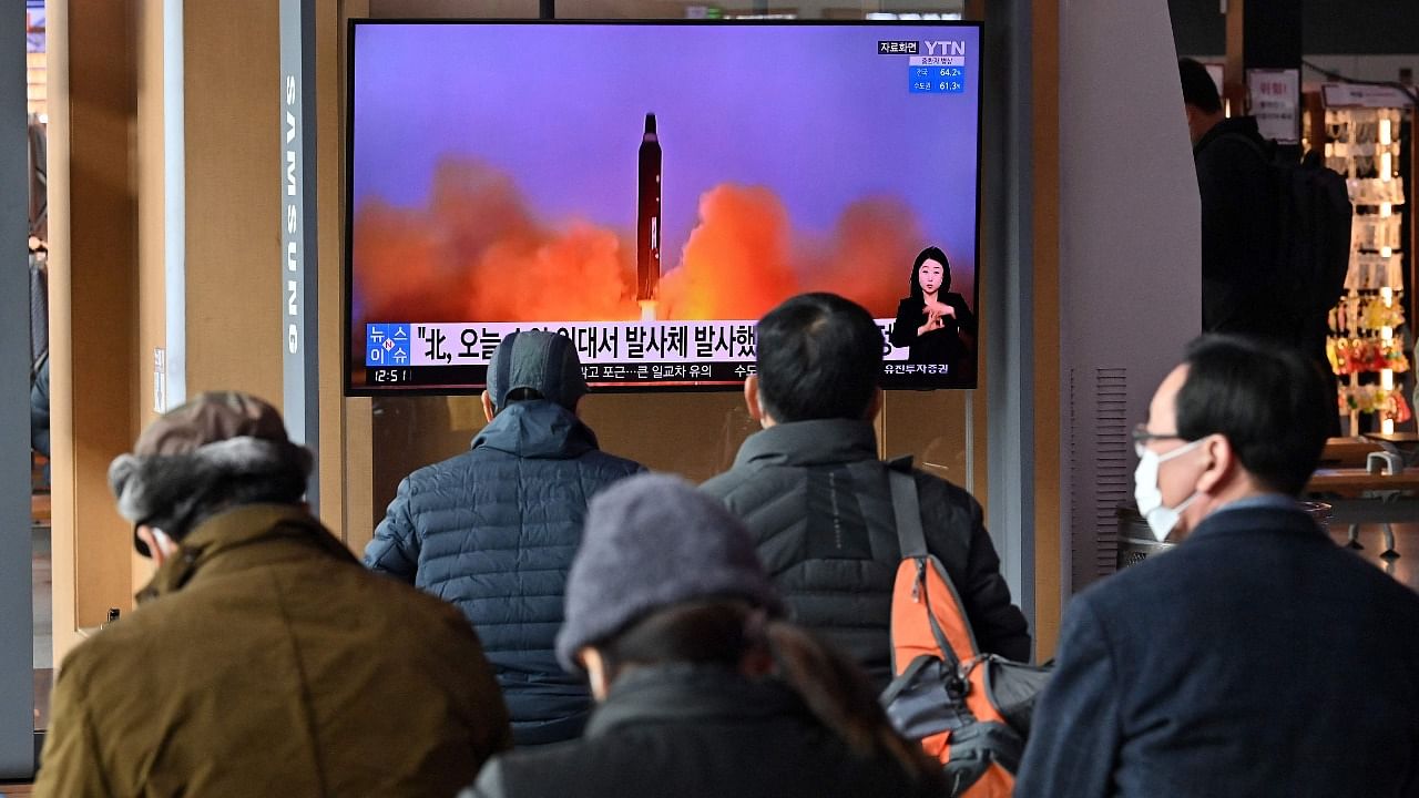 People watch a television screen showing a news broadcast with file footage of a North Korean missile test, at a railway station in Seoul. Credit: AFP Photo