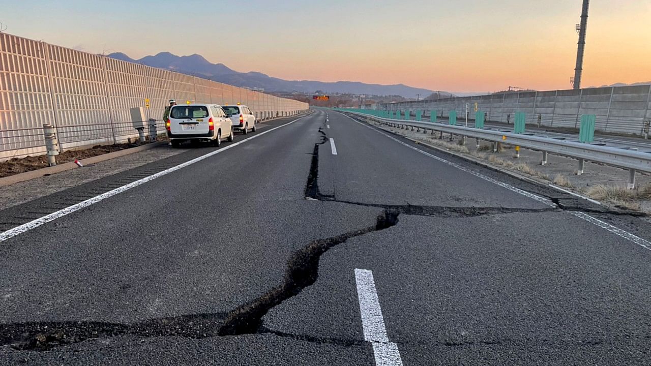 This handout picture by NEXCO East Nippon Expressway Company shows cracks on a damaged road between Kunimi IC and Shiroishi IC on the Tohoku Expressway (down line) in Shiroishi, Miyagi prefecture, after a 7.3-magnitude earthquake jolted eastern Japan. Credit: AFP Photo/NEXCO East