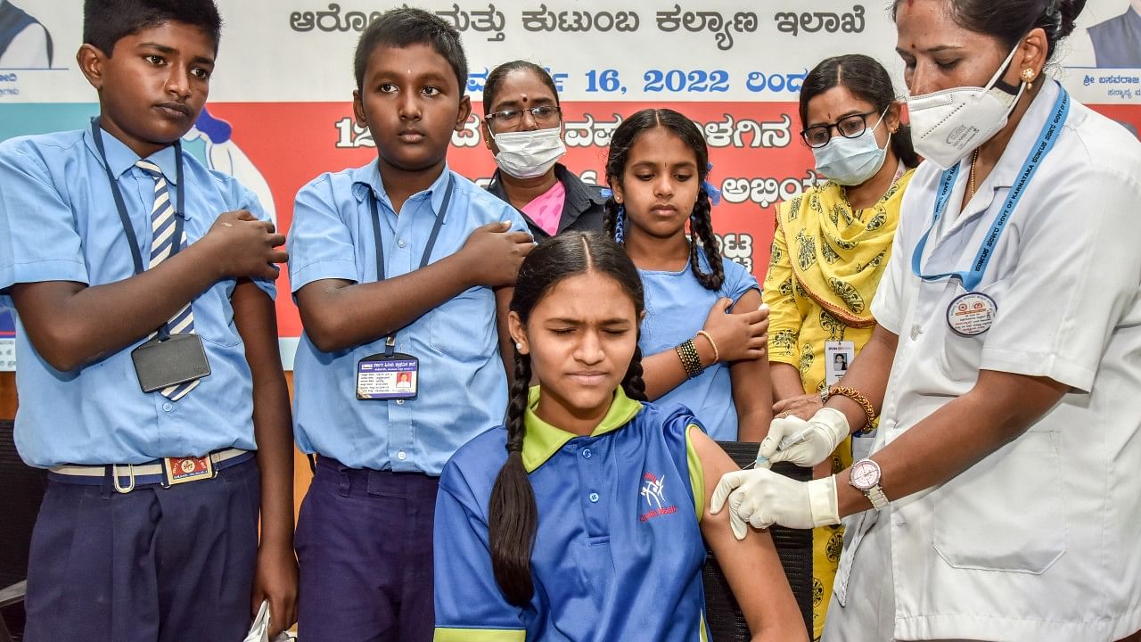 Children, aged 12 to 14 years, get the Corbevax vaccine at Atal Bihari Vajpayee College in Bengaluru on Wednesday. Credit: DH Photo/Anup Ragh T