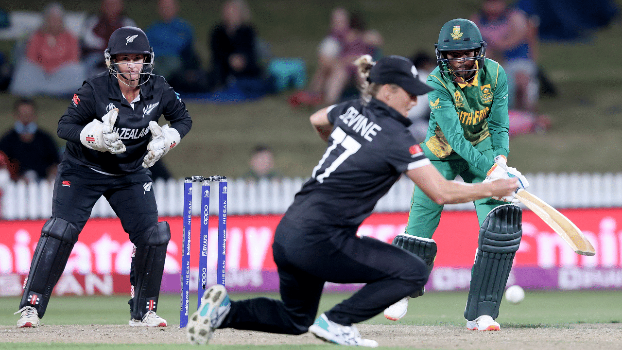 South Africa’s Ayabonga Khaka (R) hits the winning shot watched by New Zealand’s wicketkeeper Katey Martin (L) and Sophie Devine (C) during the 2022 Women's Cricket World Cup match between New Zealand and South Africa at Seddon Park. Credit: AFP Photo