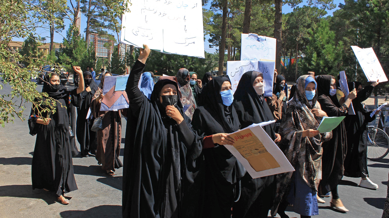 Afghan women hold placards as they take part in a protest in Herat. Credit: AFP Photo