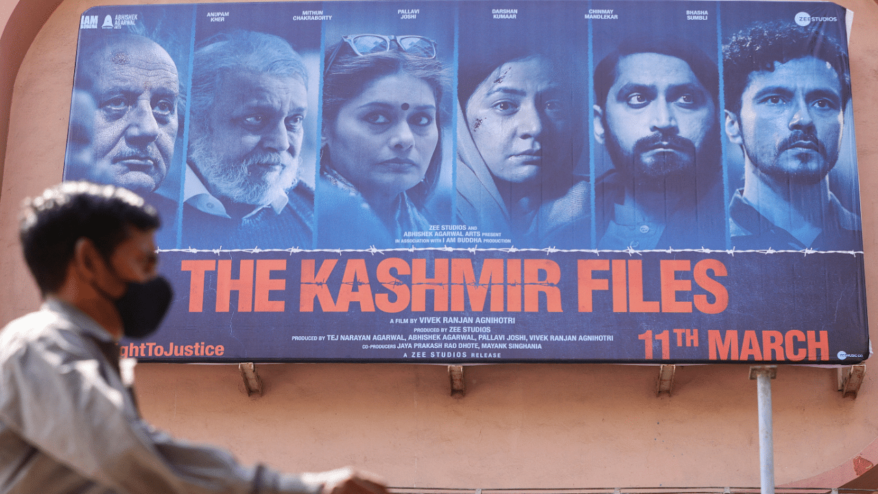 A man walks past a poster of Bollywood movie 'The Kashmir Files' outside a cinema in Mumbai. Credit: Reuters Photo