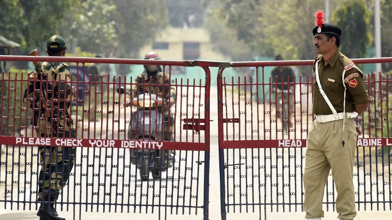 Border Security Force (BSF) personnel stand guard at the entrance gate of their headquarters where a fratricidal incident happened in Khasa on the outskirts of Amritsar. Credit: AFP File Photo